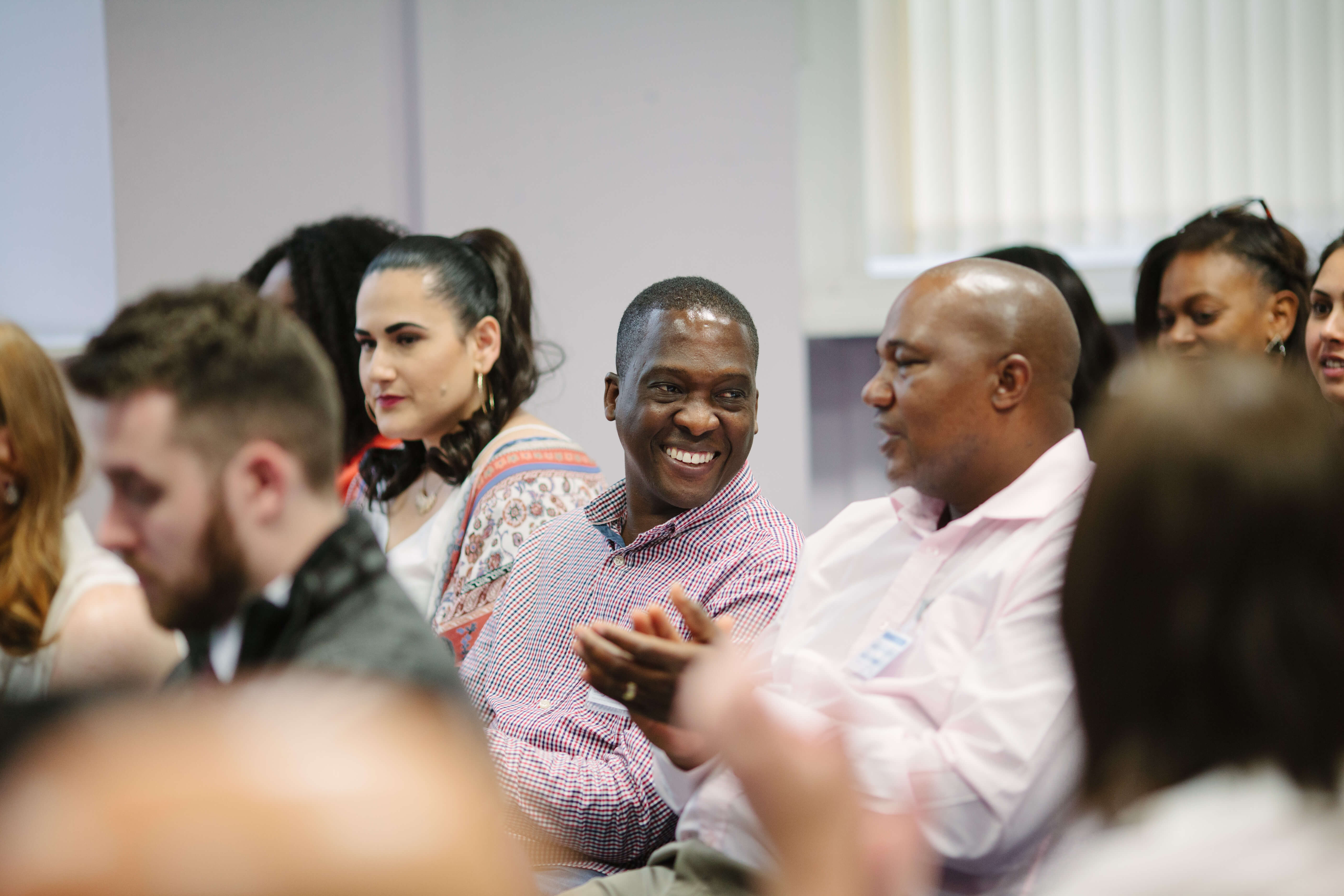 2 mean having a conversation and laughing sat down at a conference