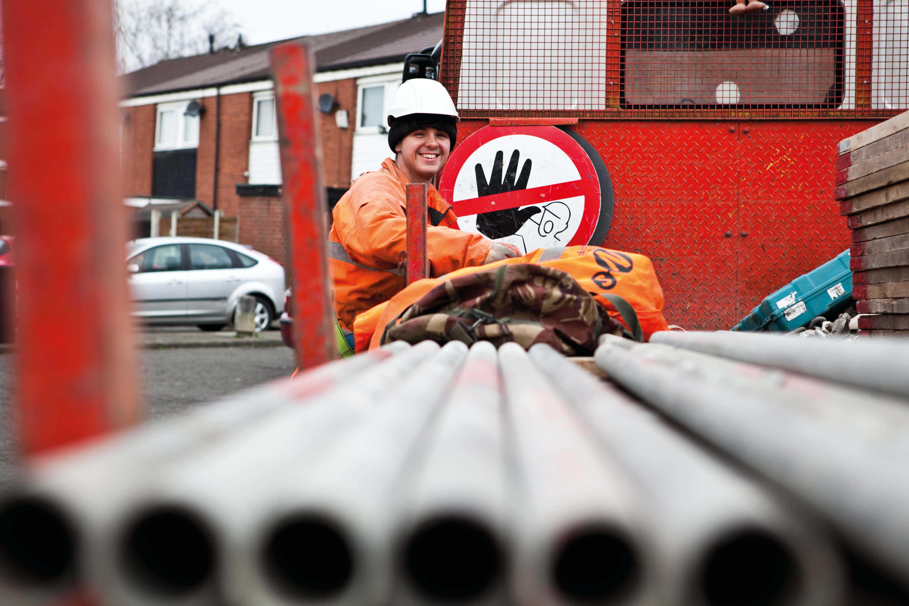 A builder unloading EN 1090 Structural Steal from a load.