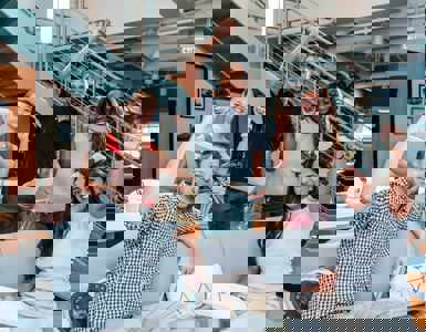 Work team celebrating ISO 45003 Certification with fists in the air.