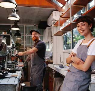 baristas in a coffee shop working in a happy environment