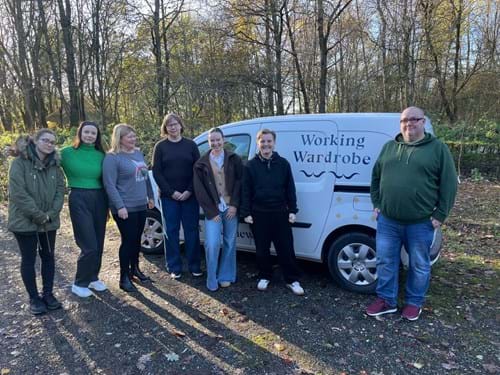 Group of volunteers stood next to a charity van